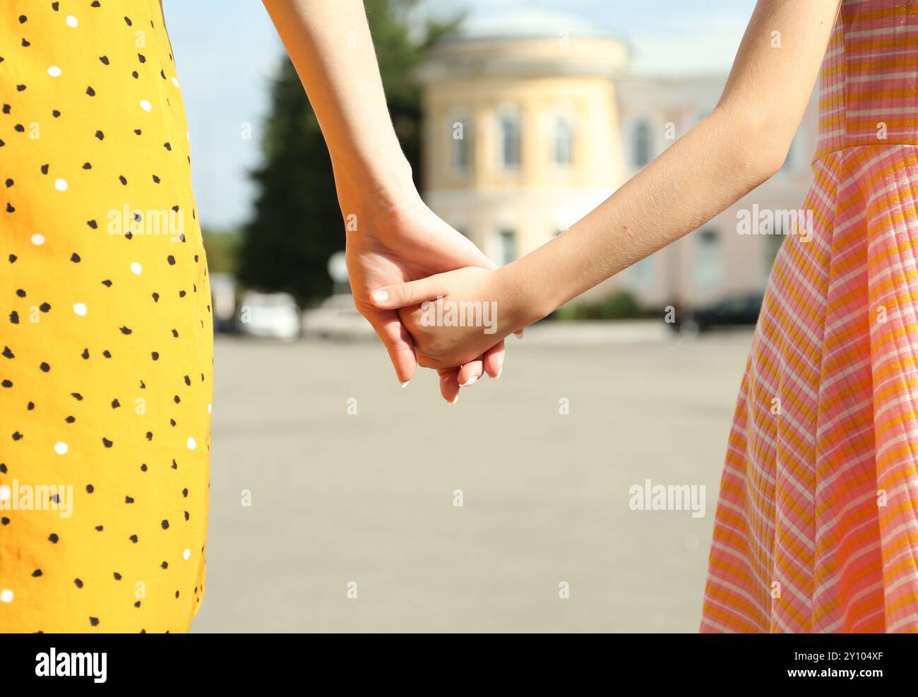 Mother and daughter holding hands outdoors, closeup Stock Photo - Alamy