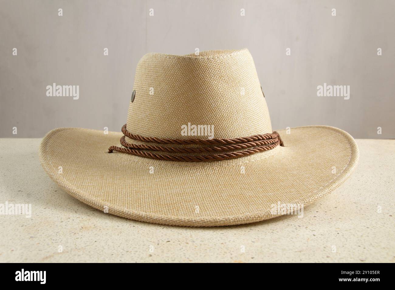 closeup of brown straw hat and hat strap detail front view, gray ...