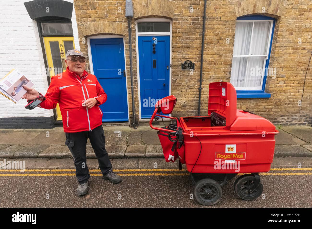 England, Kent, Sandwich, Royal Mail Postman delivering Mail Stock Photo