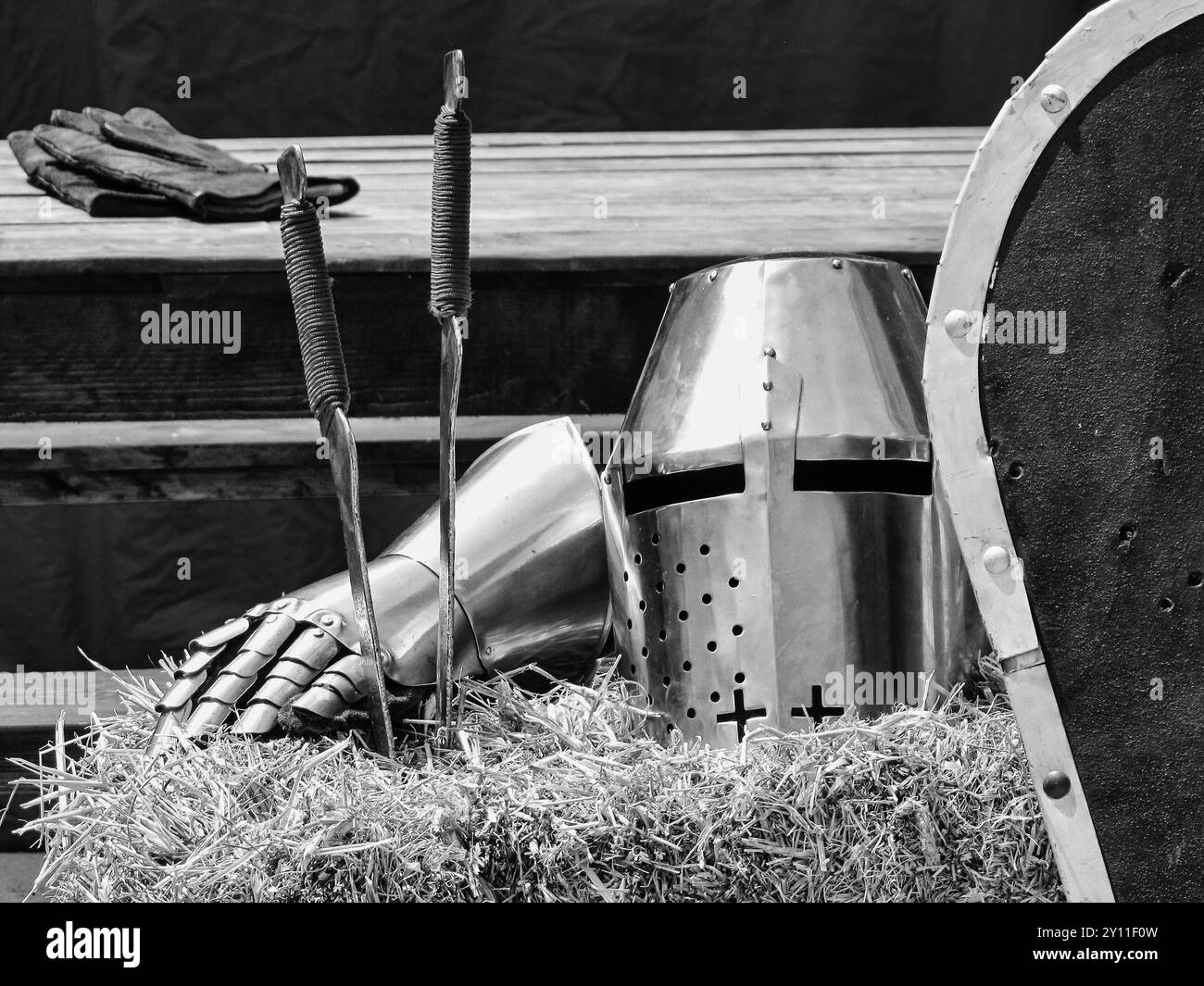 Medieval suit of armor and a  steel helmet in an outdoor still-life Stock Photo