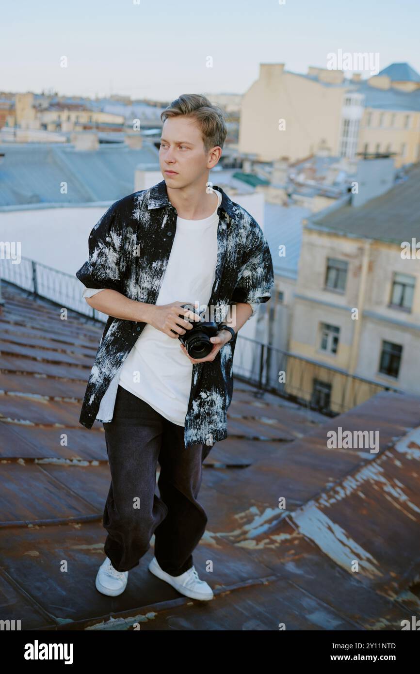 Exploring Rooftops Holding Camera in Urban Setting Stock Photo