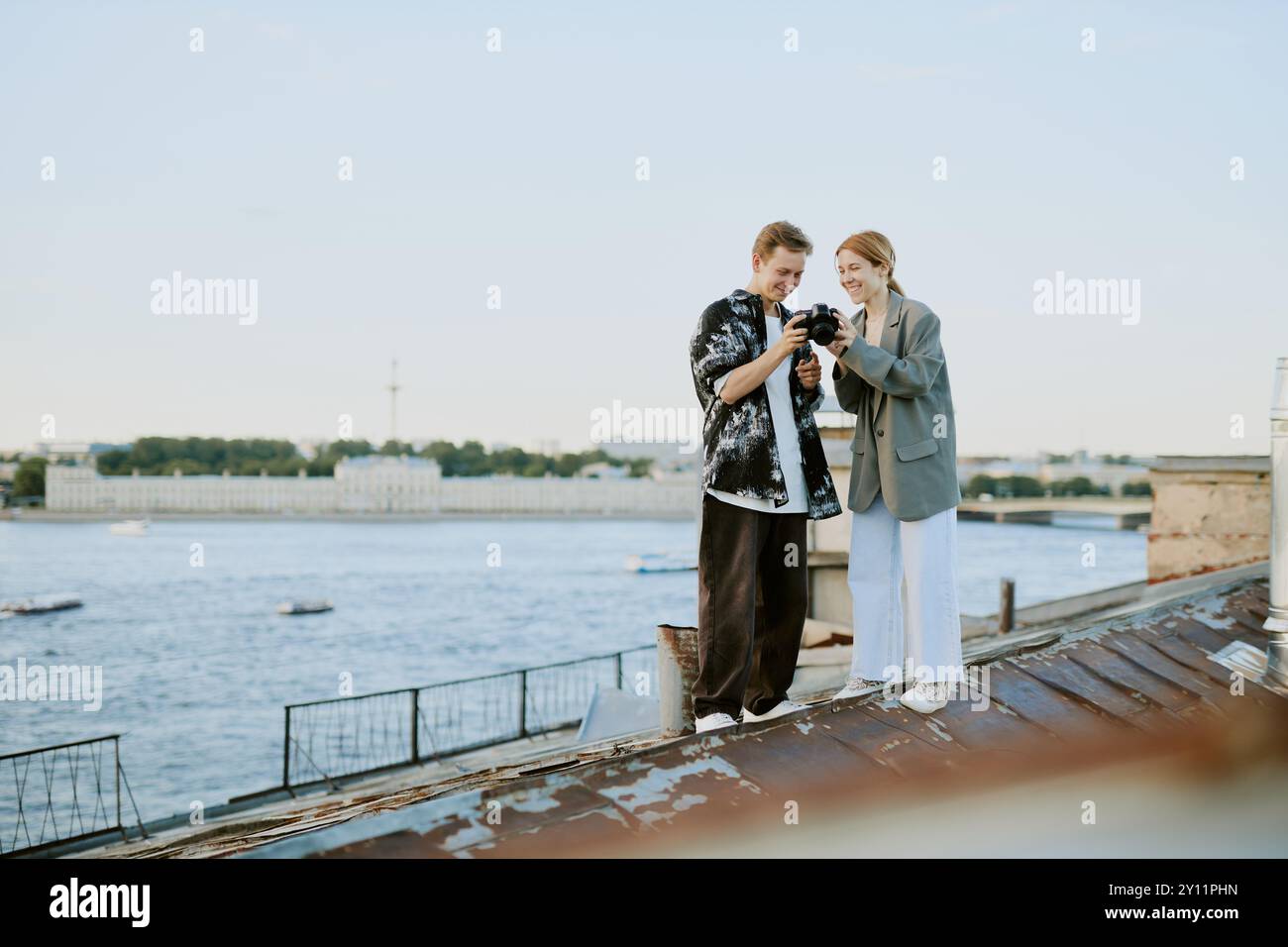 While Viewing Sharing Moment While Viewing Photos on Rooftop Stock Photo - Alamy