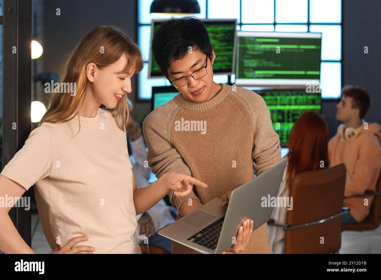 Young programmers working with laptop in office Stock Photo