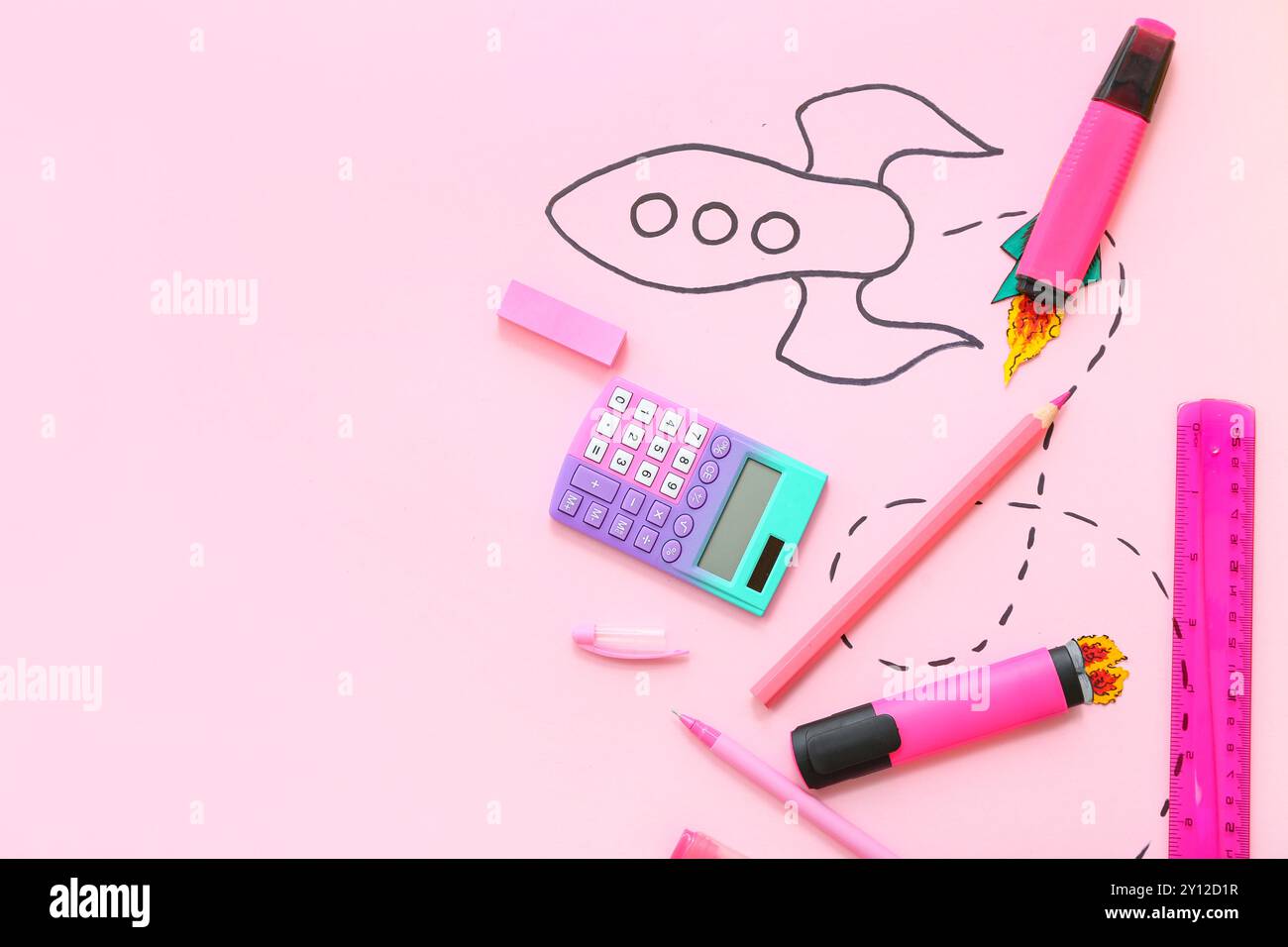 Creative composition with drawn rocket and different stationery on pink background Stock Photo