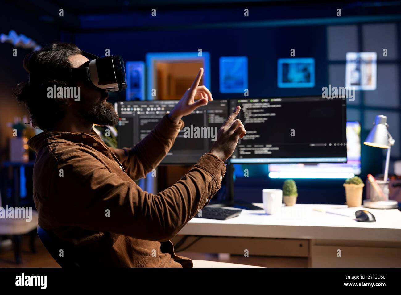 Man doing software quality assurance, reading source code using high tech VR headset. Developer inspecting coding using virtual reality technology, looking to fix potential issues Stock Photo