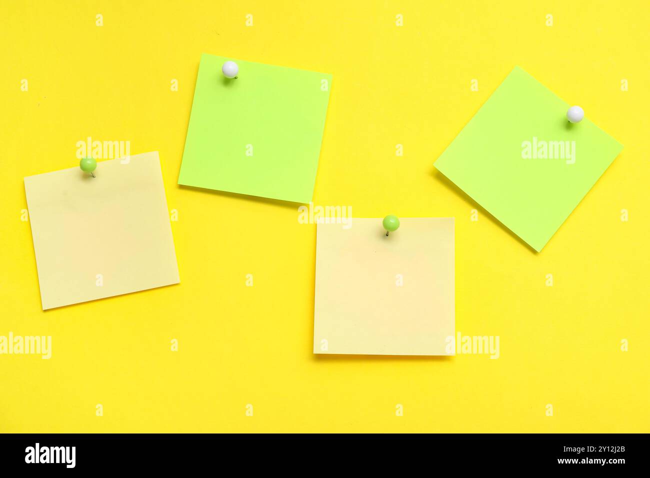 Paper notes pinned on yellow background Stock Photo