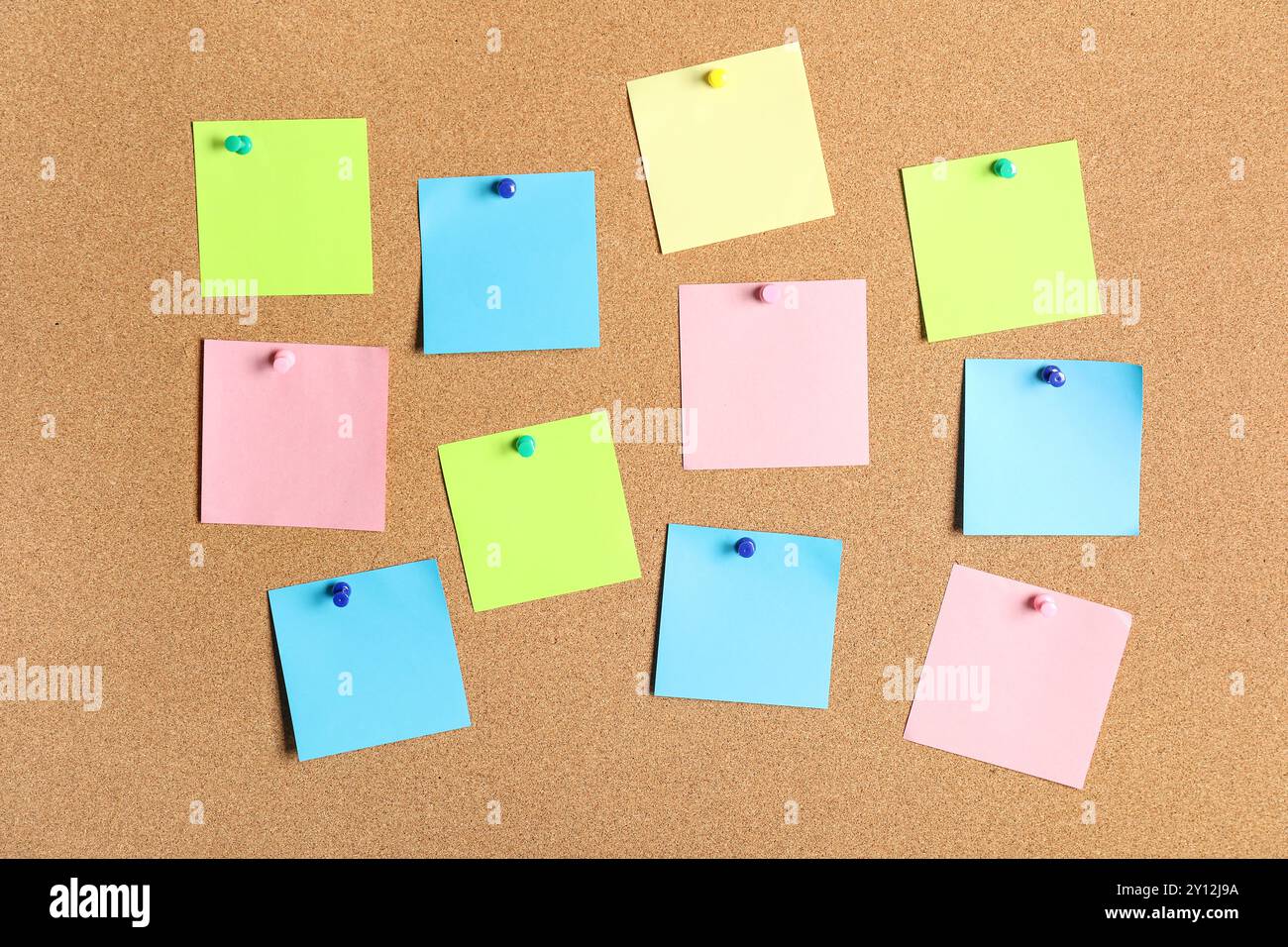 Different blank sticky notes on cork board as background Stock Photo