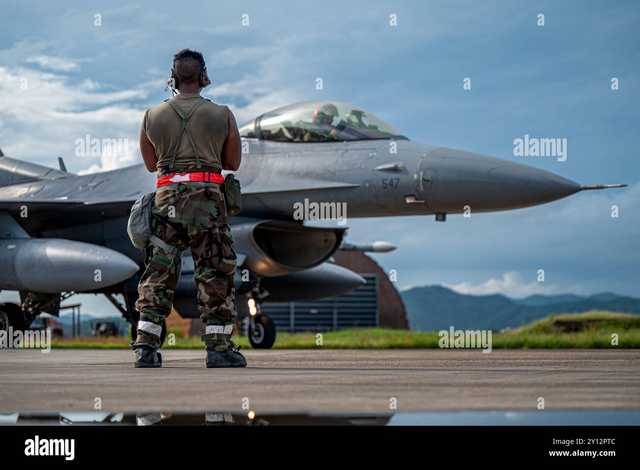 U.S. Air Force Senior Airman Adrian Quiroz, 36th Fighter Generation Squadron crew chief, prepares an F-16 Fighting Falcon aircraft for takeoff during Stock Photo