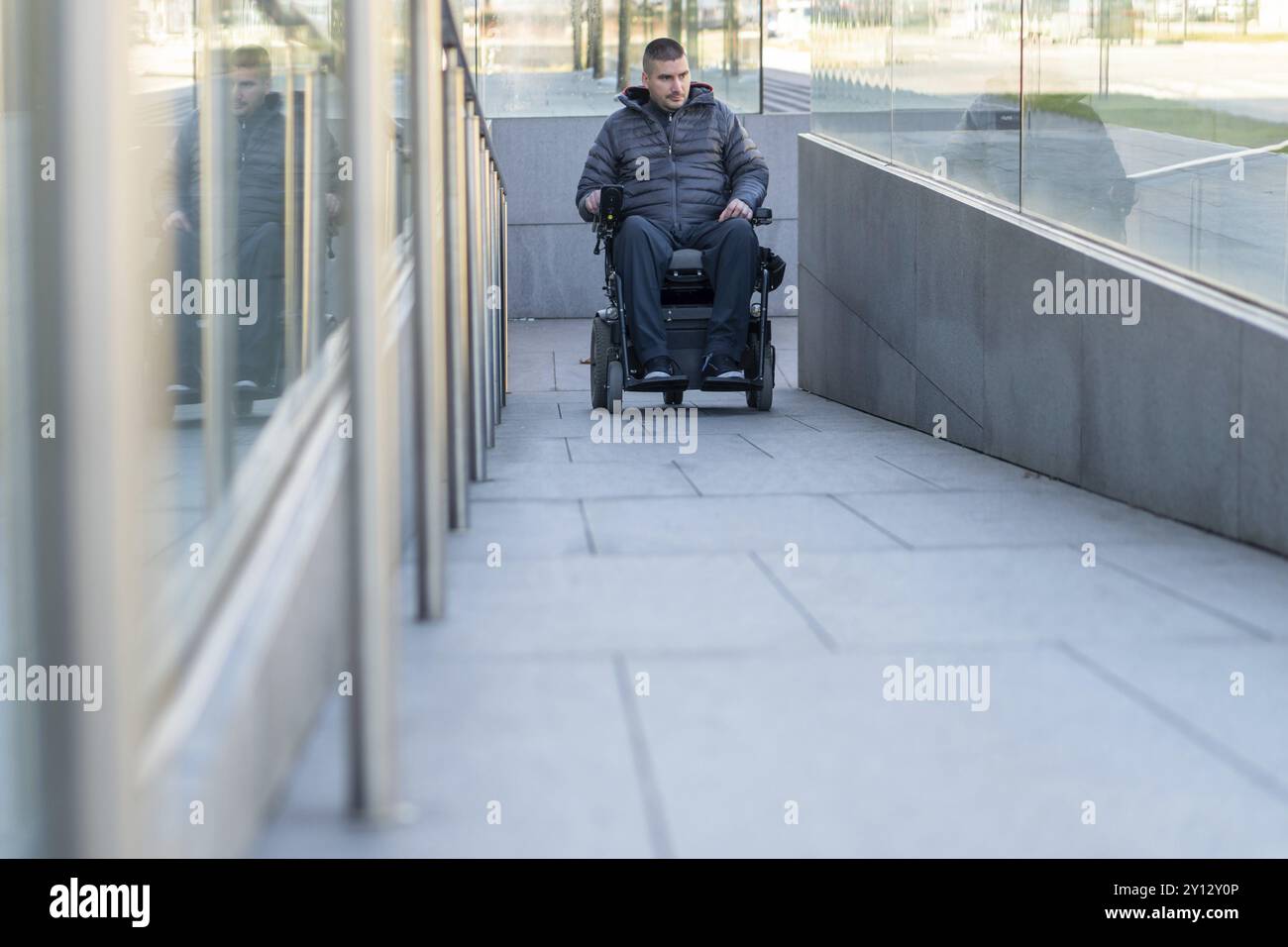 Someone Using A Ramp Man in a wheelchair using a ramp next to stairs Stock Photo - Alamy
