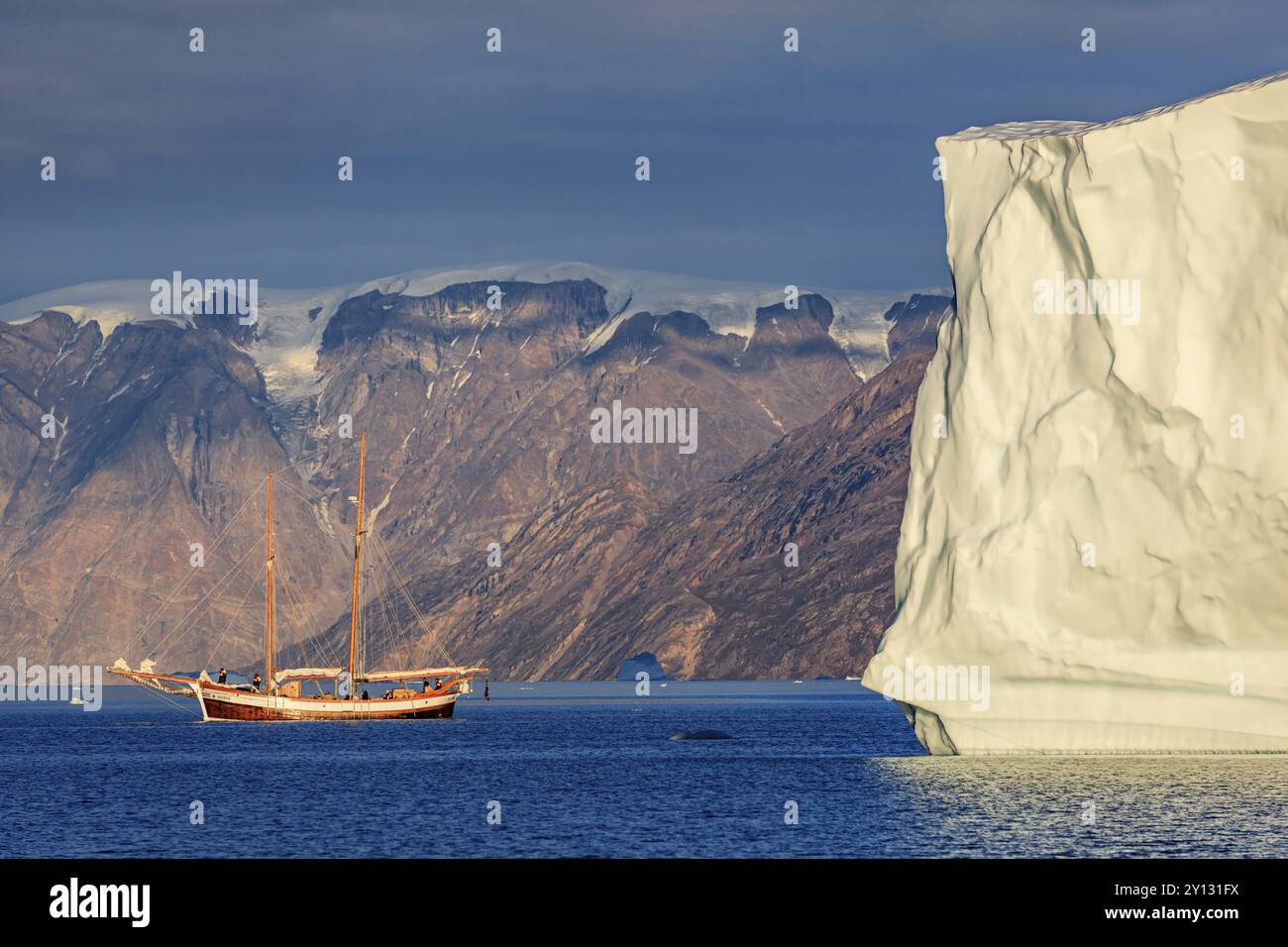 Smith Sound Sailing boat, ship in fjord in front of large icebergs and mountains ...