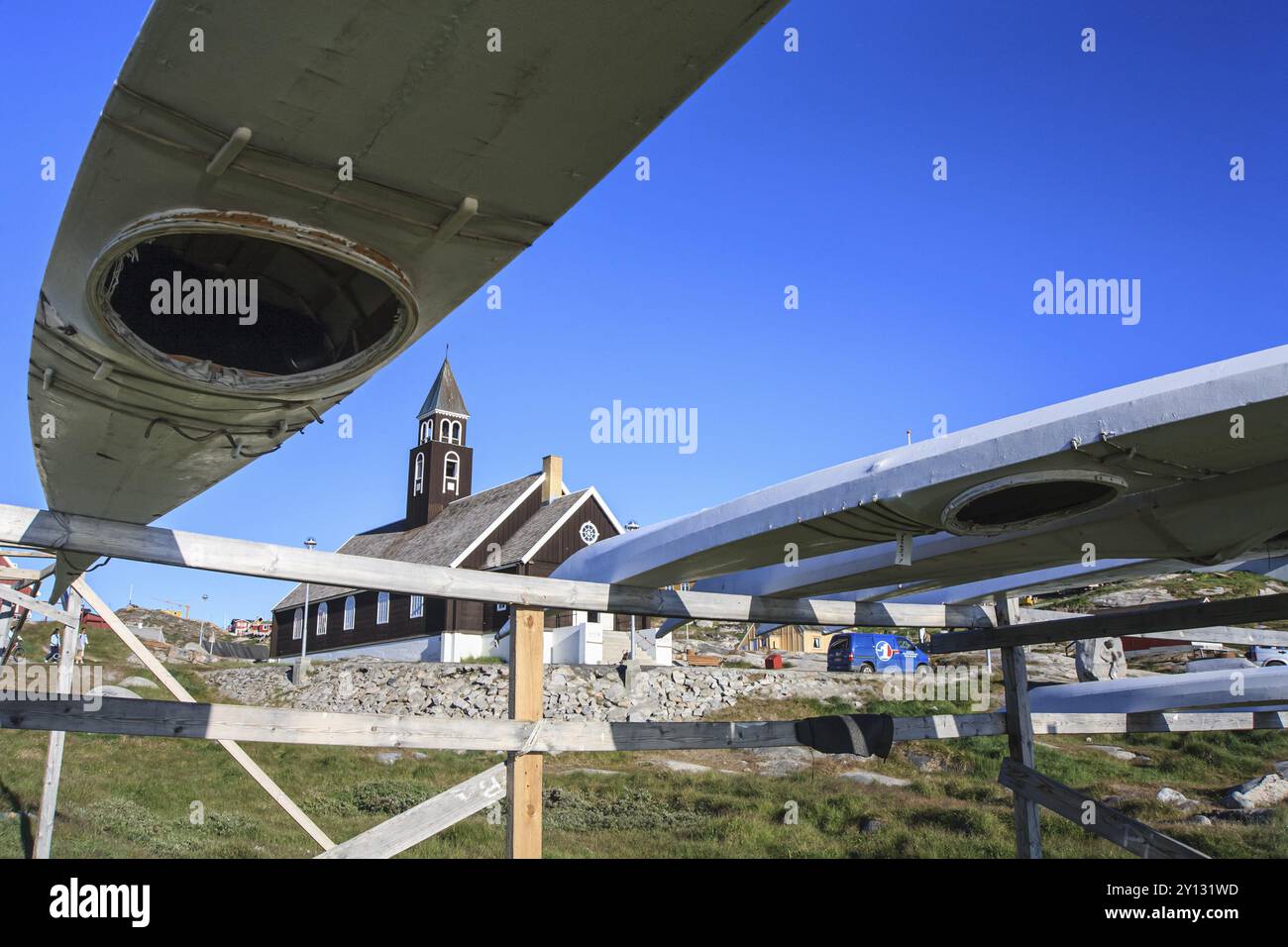 Traditional kayaks on a wooden frame in front of a church, summer, Inuit, Zion's Church, Ilulissat, Ilulissat Icefjord, Disko Bay, West Greenland, Gre Stock Photo