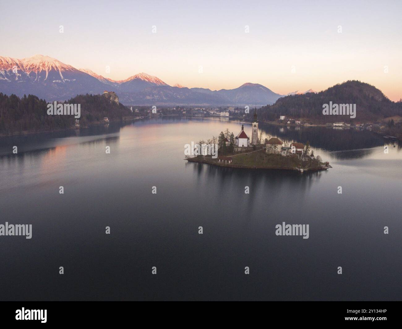 Aerial photo of wonderful Bright Autumn landscape during sunset. Awesome Fairy tale lake Bled in Julian Alps, Slovenia, Europe. Amazing Aerial View at Stock Photo