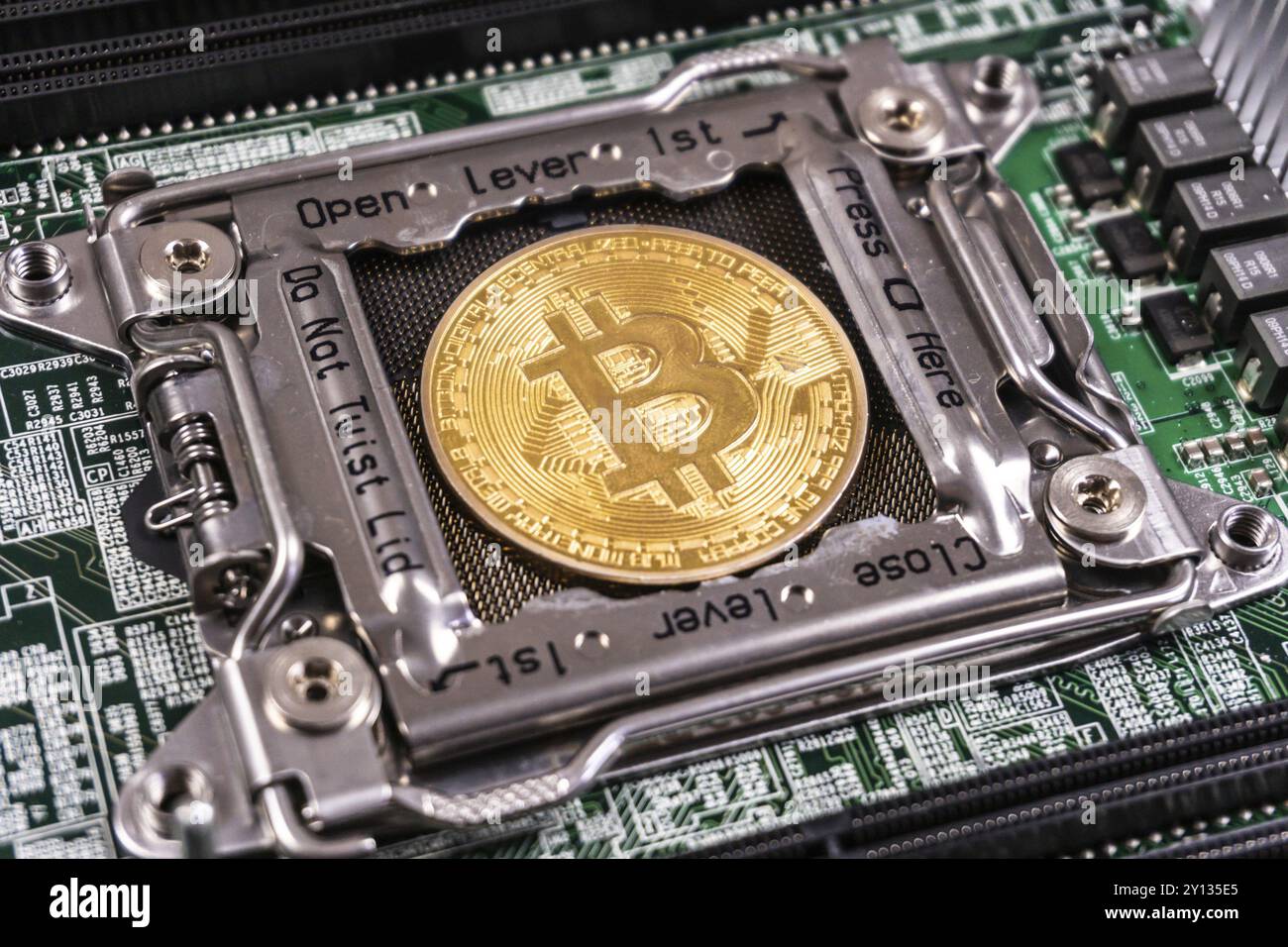 Golden Bitcoin Cryptocurrency on computer circuit board. Blockchain and security concept Stock Photo