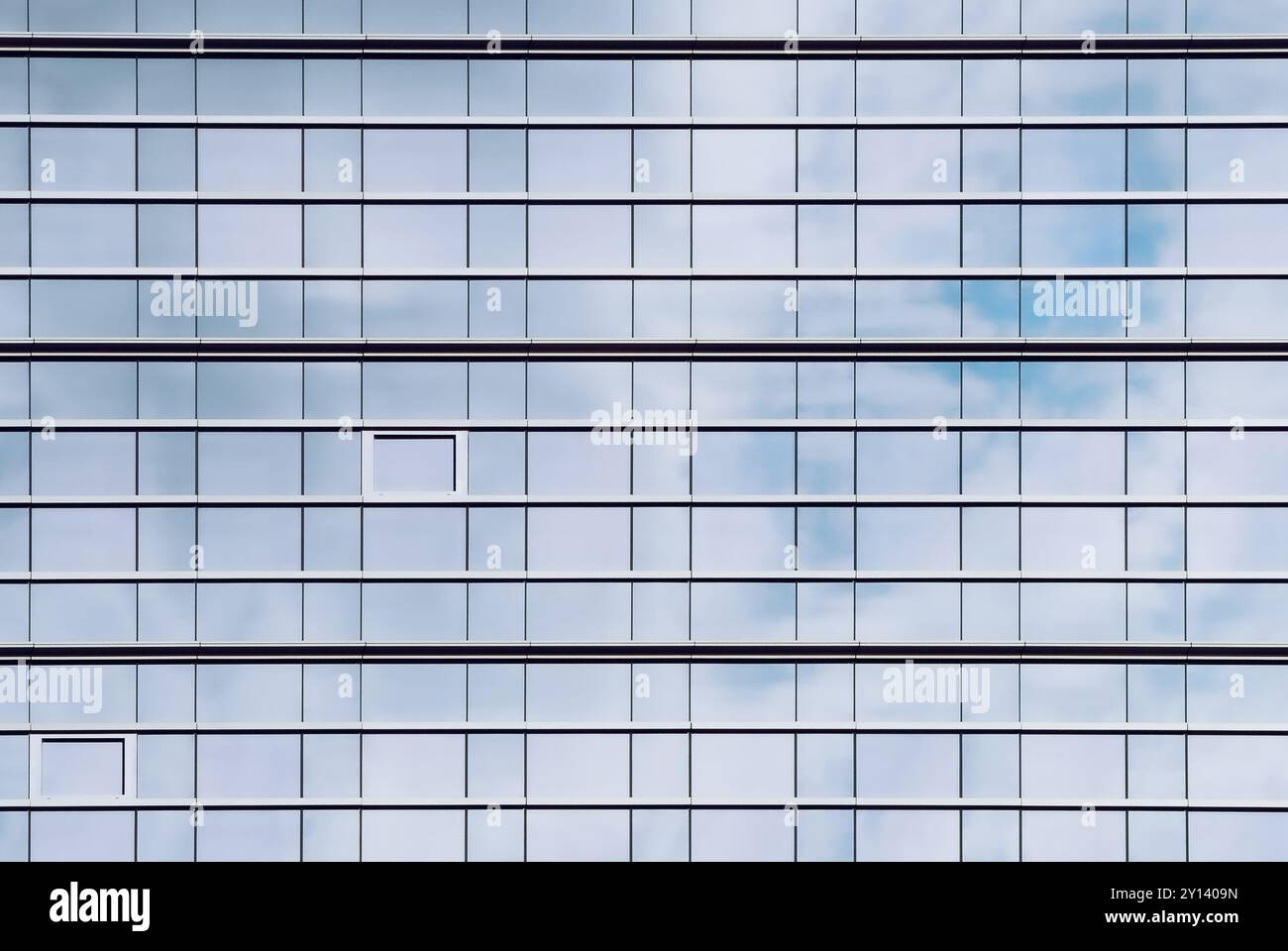 Image showcasing Glass facade of office buildings where the windows reflect the cloudy ...