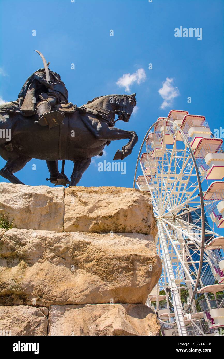 Tirana, Albania - May 30 2024. Monument to Albanian national hero, Gjergj Kastrioti Skanderbeg, in Skanderbeg Square, and the Tirana Eye Ferris Wheel Stock Photo