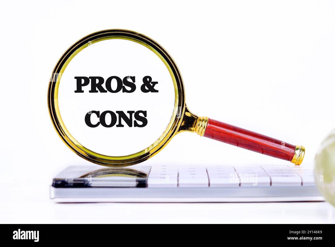 PROS and CONS message through a magnifying glass, close-up on a ...