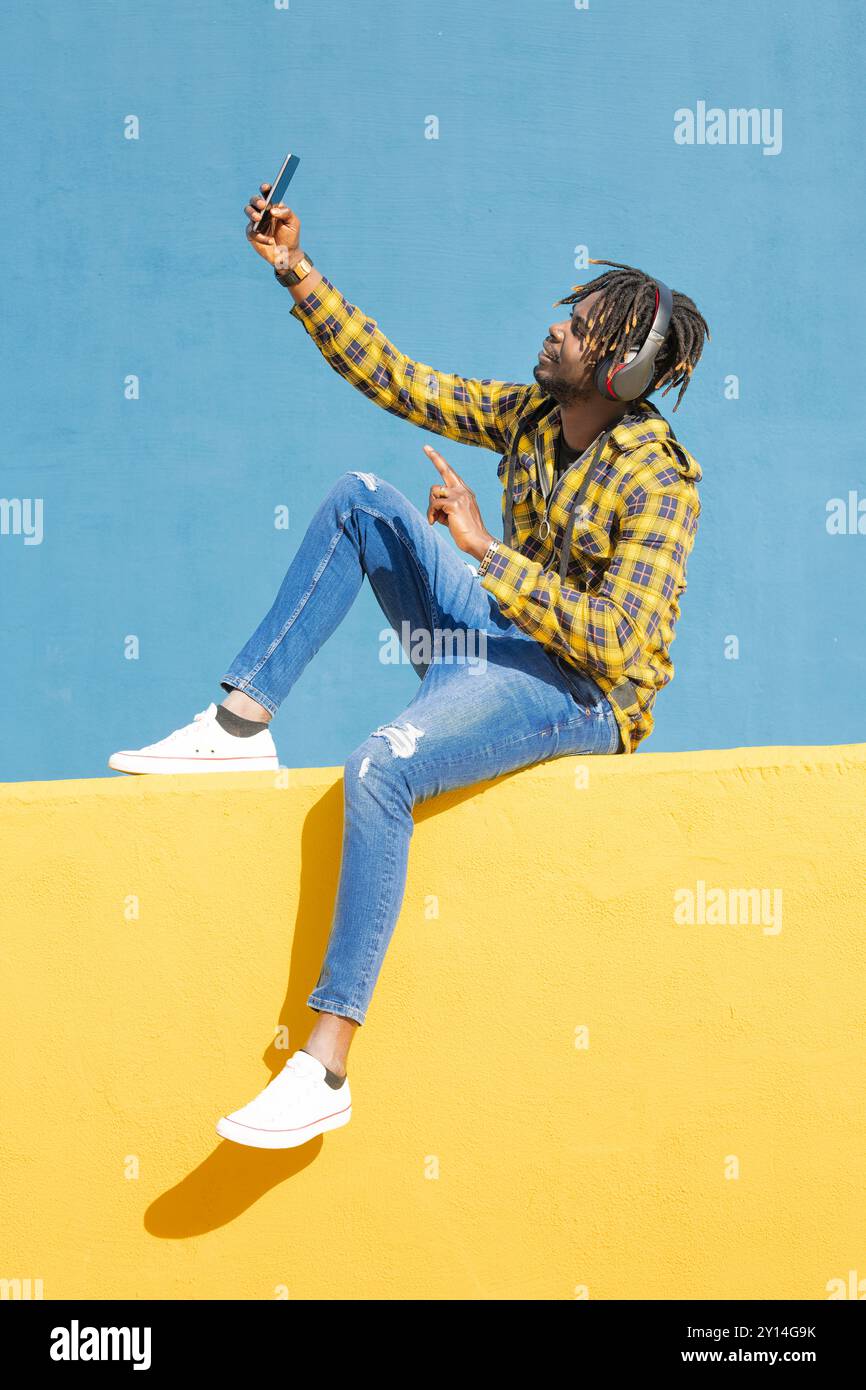 black man with headphones making a video call Stock Photo