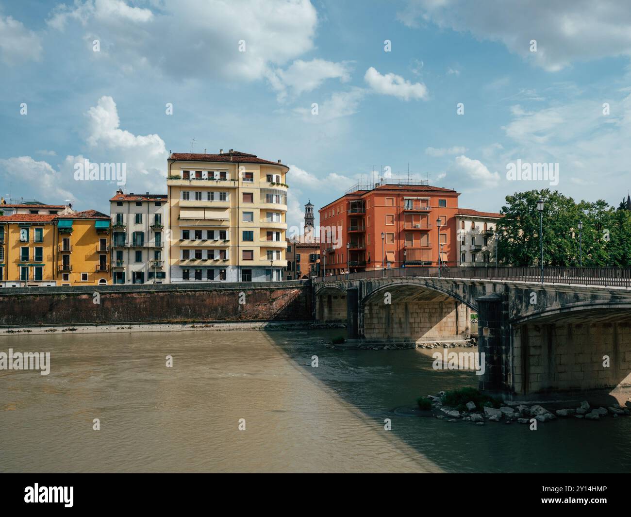 A vibrant riverside scene featuring historic buildings in various ...