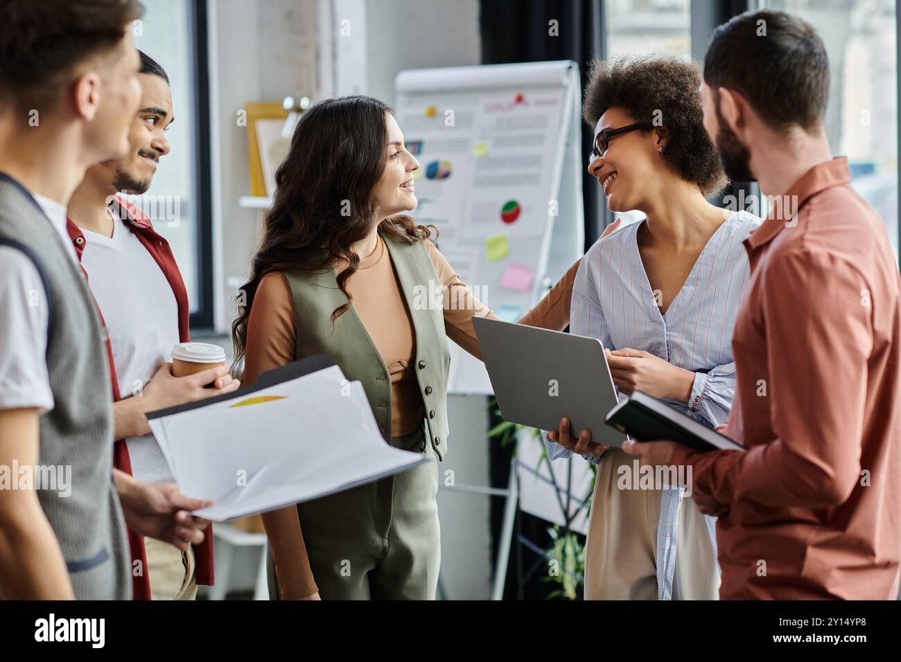 Professionals in elegant attire share warm farewells amidst impending time. Stock Photo