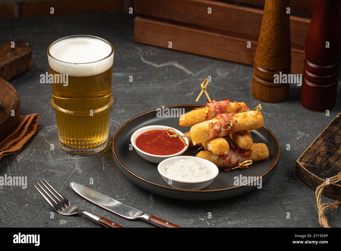 Fried mozzarella sticks with bacon with beer Stock Photo - Alamy
