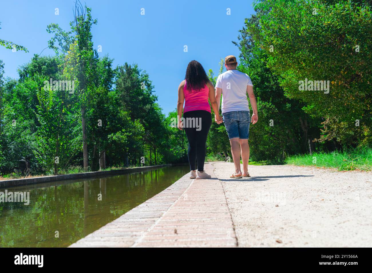 Couple walking on a path in the park. Back view Stock Photo - Alamy