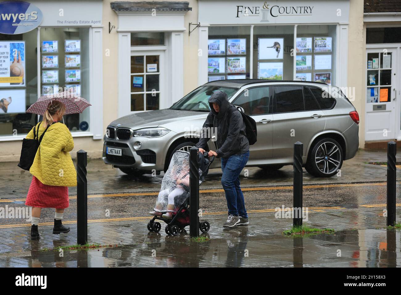 Stroud,UK, 5th September 2024. UK Weather. Heavy rain downpours , as shoppers use umbrellas and waterproofs in Stroud, Gloucestershire. Credit: Gary Learmonth / Alamy Live News Stock Photo