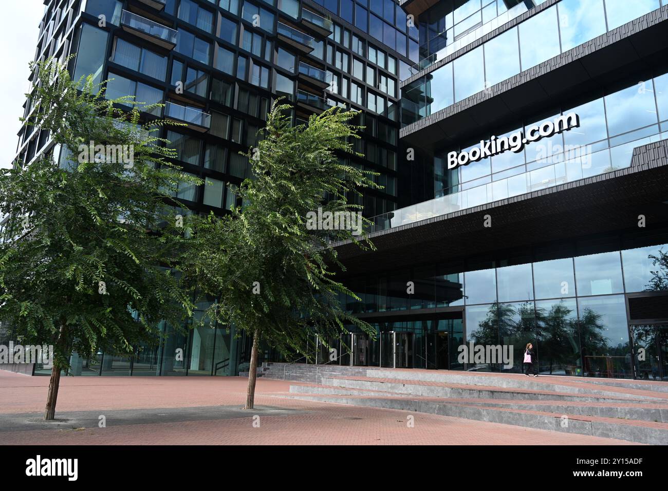 Amsterdam, Netherlands - August 24, 2024: The Booking.com HQ in Amsterdam. Booking.com is one of the largest online travel agencies. Stock Photo