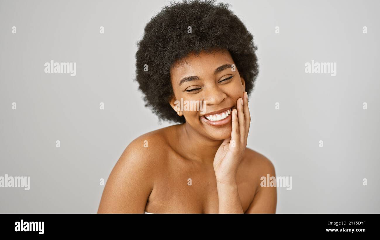 Portrait of a joyful african american woman with curly hair isolated on ...