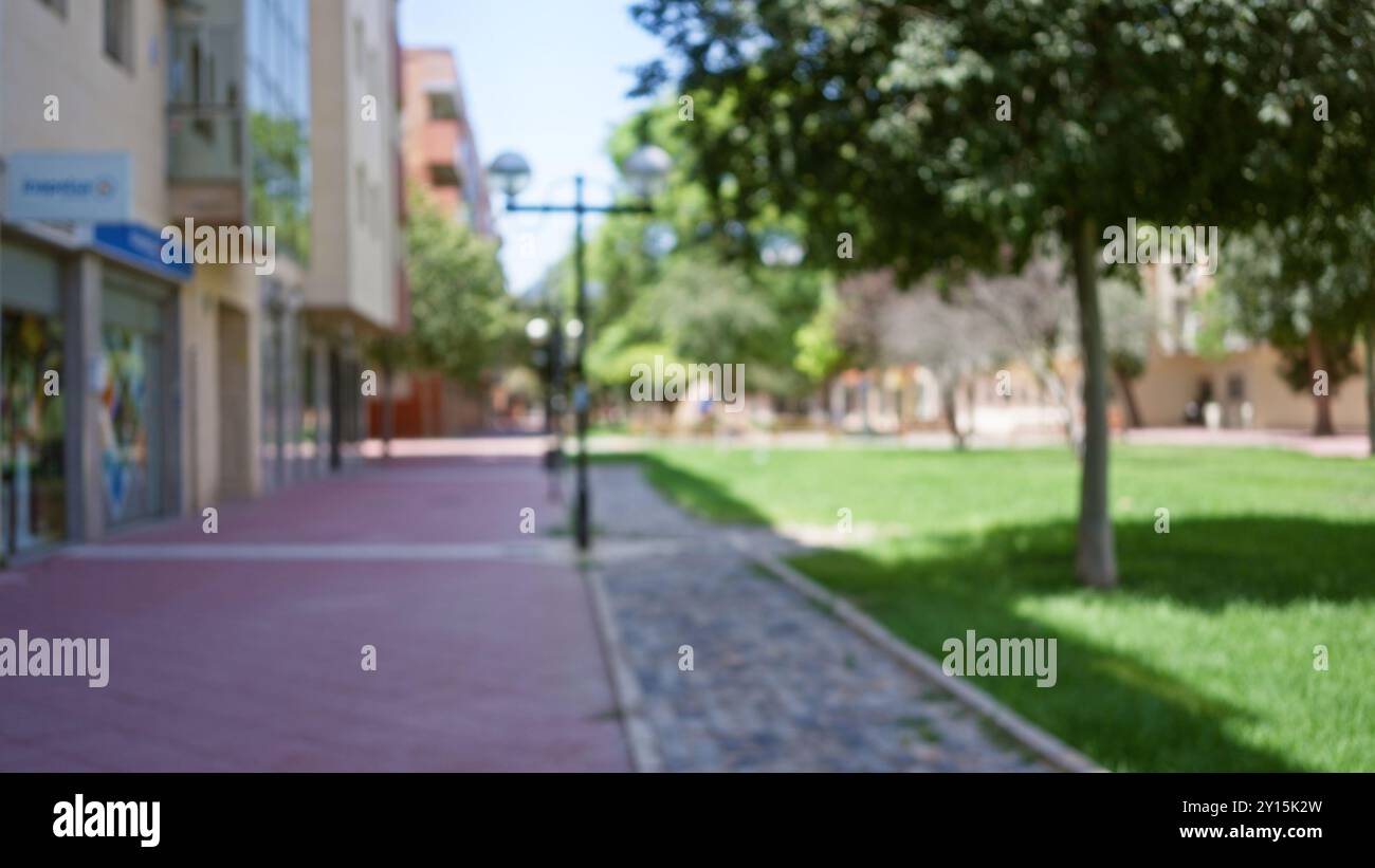 Blurred street scene with bokeh effect showing a defocused park and ...