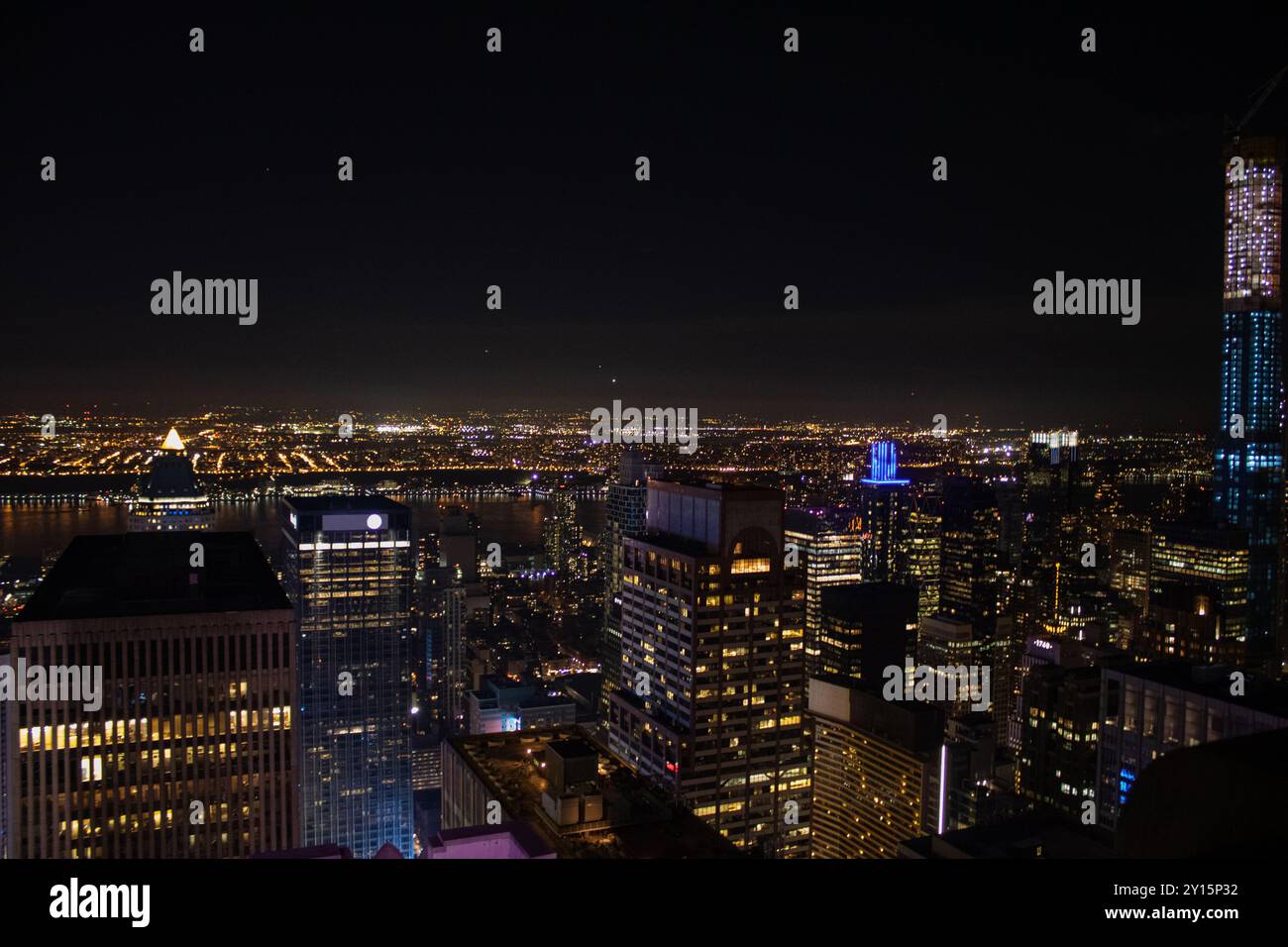 Night time aerial view of Manhattan in New York City showing the ...