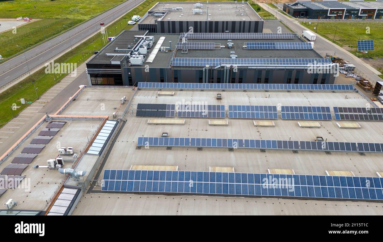 Aerial view of a modern industrial building with solar panels on the ...