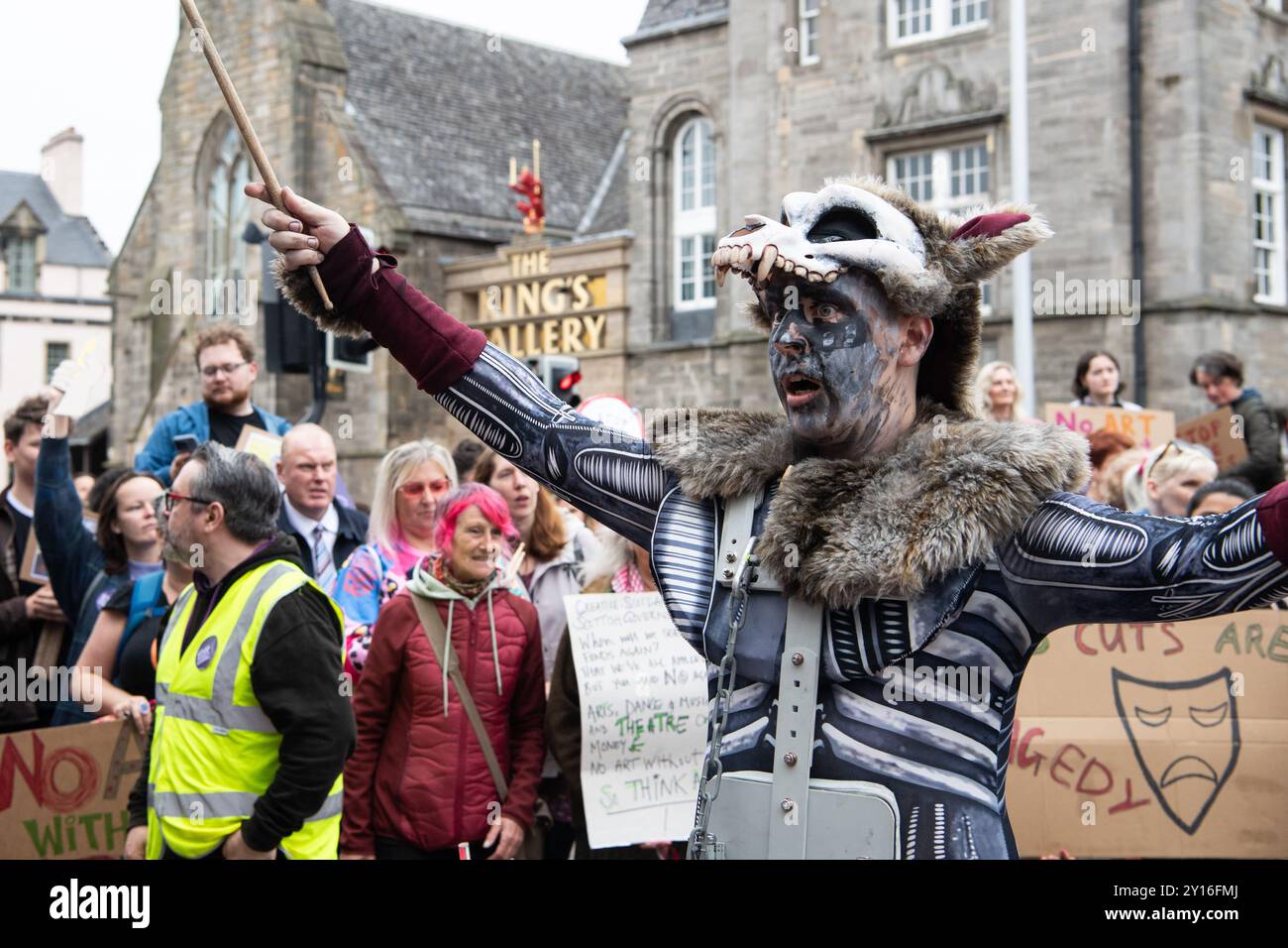 Surge Scotland performing a funereal excerpt from their large-scale street spectacle and musical pandemonium show 'Beautiful Bones', as part of a protest outside Scottish Parliament on 5 September 2024 in response to Creative Scotland announcing its decision on 19 August to abolish its fund for individual arts professionals due to funding constraints from the Scottish government; an announcement was made late on 4 September that the fund would be reinstated, however there are ongoing concerns about the future of arts funding in Scotland. This protest was organised by STUC (Scottish Trades Unio Stock Photo