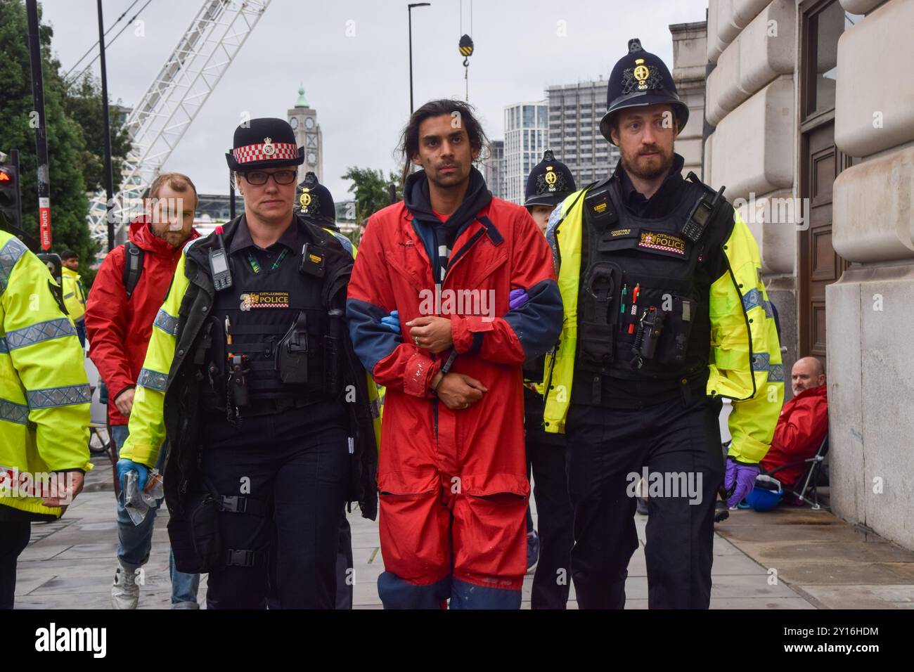 London, UK. 05th Sep, 2024. Police officers arrest a Greenpeace activists who scaled the Unilever building. Environmental group Greenpeace staged a protest at Unilever headquarters against the plastic pollution caused by the company's Dove products. Credit: SOPA Images Limited/Alamy Live News Stock Photo