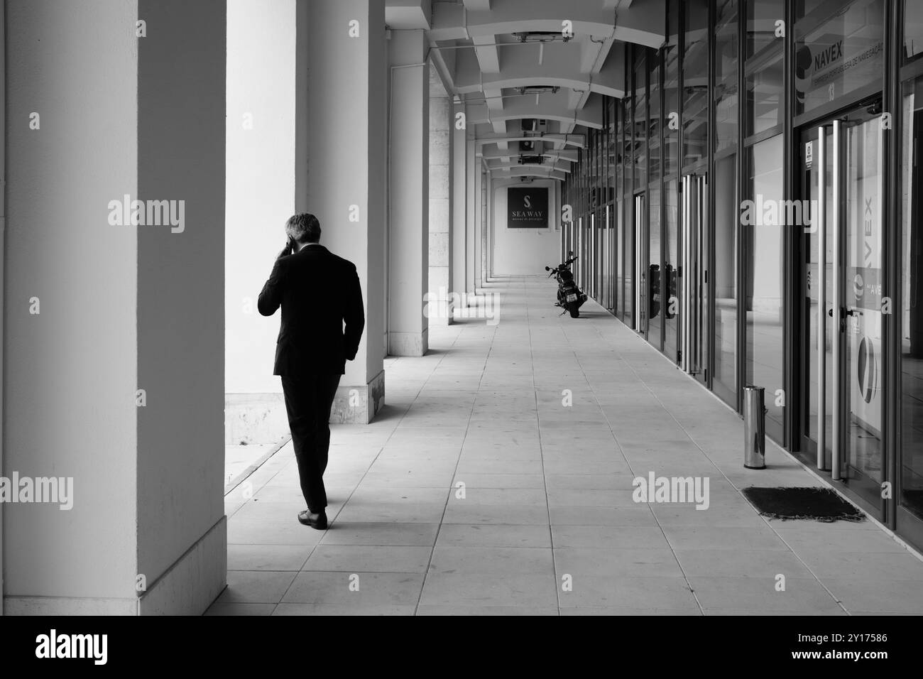 People watching in Lisbon, street photography - man in suit at Seaway premises in Tagus riverbank commercial zone. Stock Photo