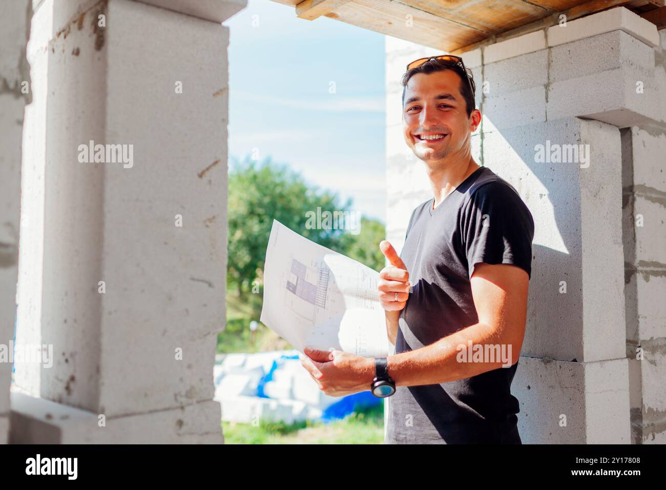 Portrait of man architect engineer checking house under construction ...