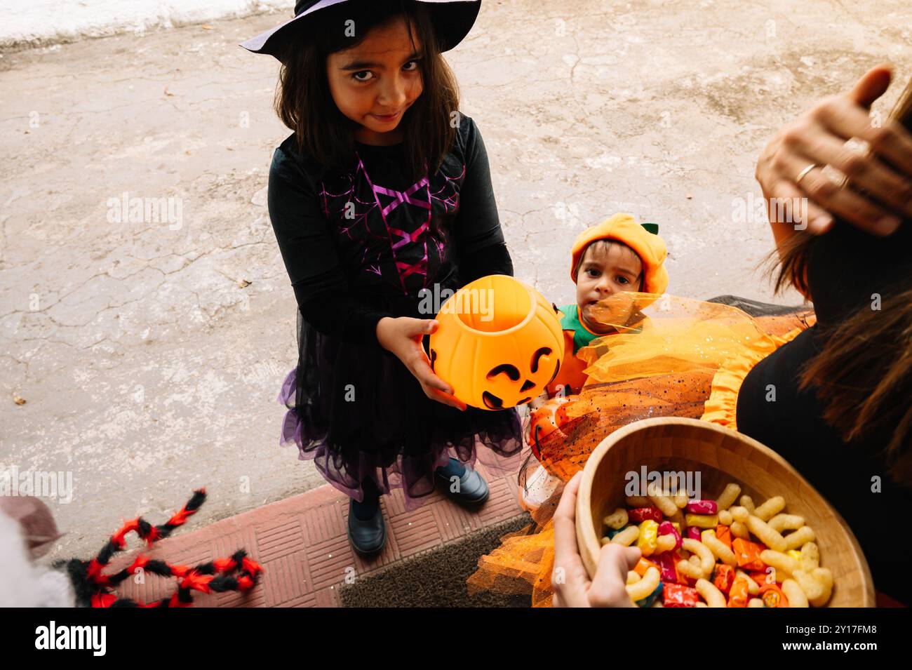 Offering Candy Children receiving halloween candy door hi-res stock photography and ...