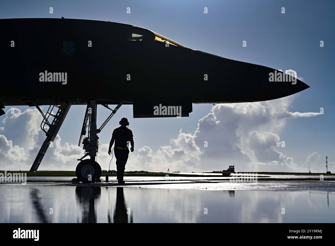U.S. Air Force Senior Airman awaits the taxi of a B-1B Lancer Bomber Stock Photo