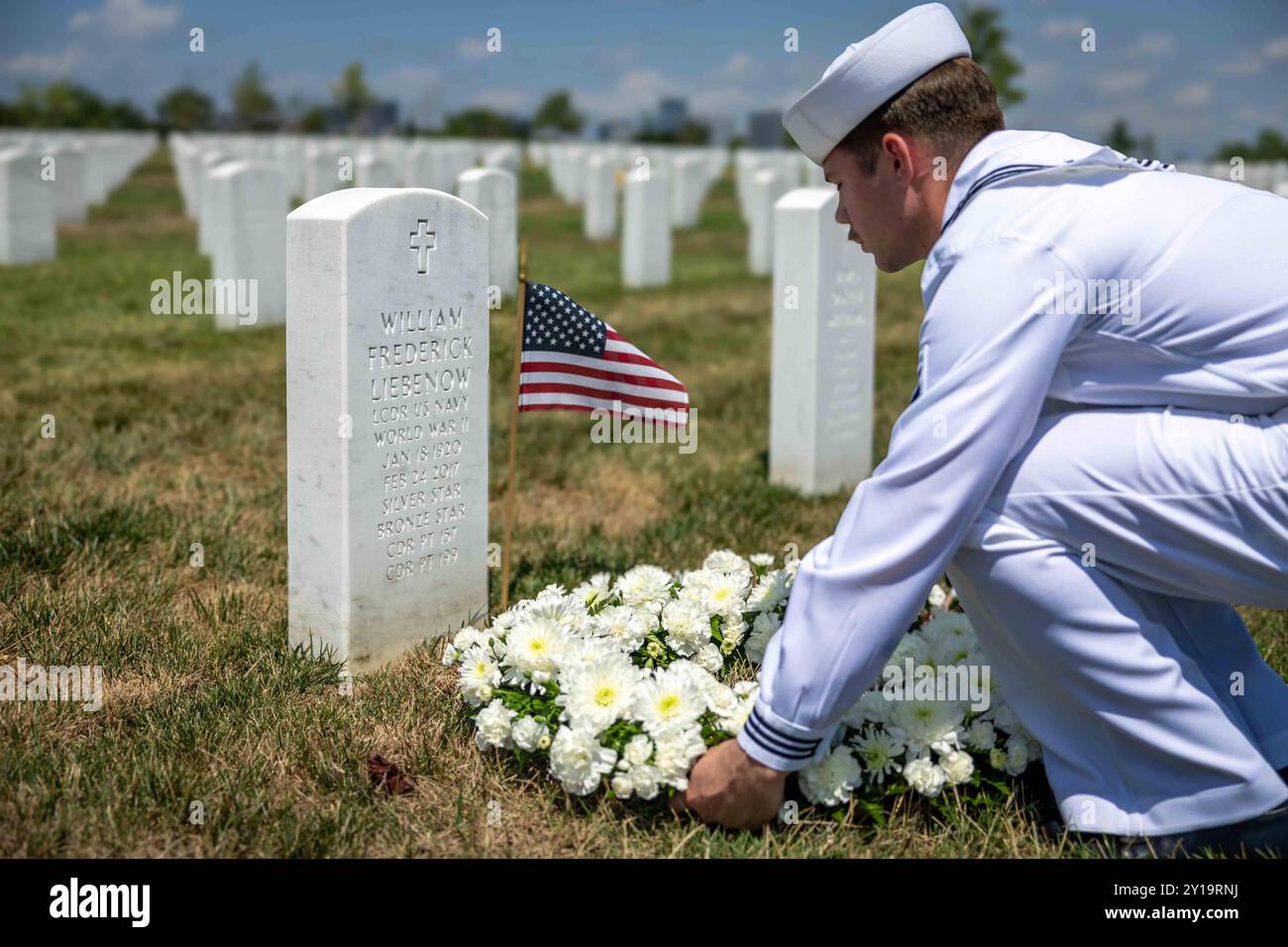 20240802-N-UP745-1004 ARLINGTON, Va. (Aug. 2, 2024) Cryptological Technician Seaman Apprentice Logan Ganong, from Temecula, Calif., lays a wreath on behalf of Sailors assigned to the Pre-Commissioning Unit John F. Kennedy (CVN 79) at the gravesite of Lt. Cmdr. William Liebenow  at Arlington National Cemetery. Liebenow served alongside the ship's namesake, then-Lt. John F. Kennedy, on PT-109. The wreath-laying marks the anniversary of the PT-109 crash. The John F. Kennedy (CVN 79) is the second Ford-class aircraft carrier under construction at Huntington Ingalls Industries' Newport News Shipbui Stock Photo