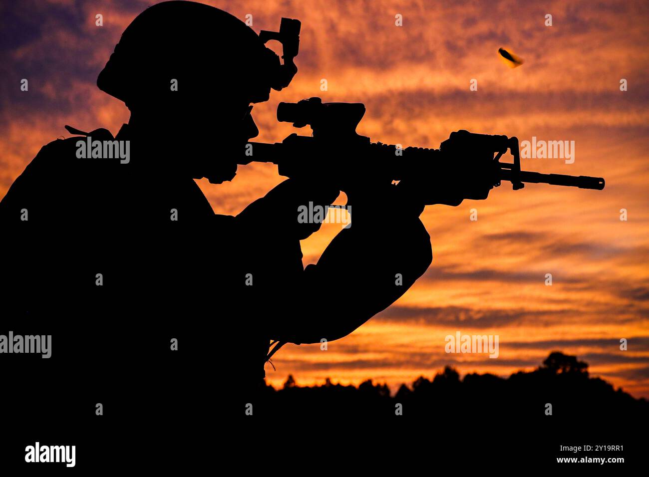 Soldier fires his weapon during advanced marksmanship training Stock Photo