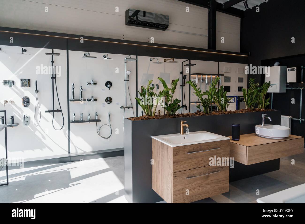 Contemporary Bathroom Showroom with Elegant Fixtures and Greenery Stock ...