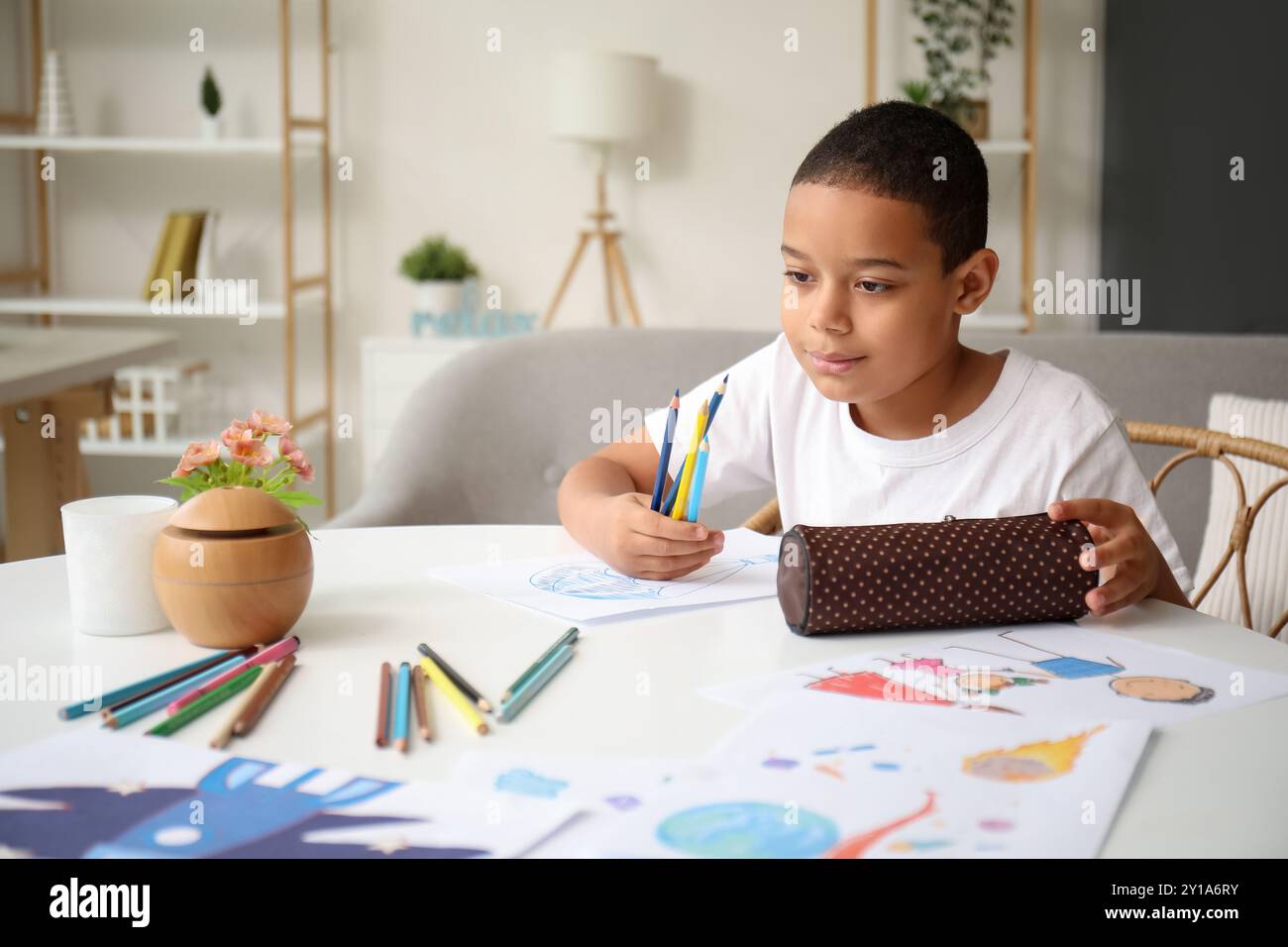 Little African-American boy with pencil case at home Stock Photo - Alamy