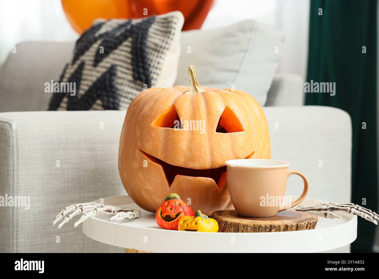 Skeleton Hand Tea Halloween pumpkins with with skeleton hands and cup of tea on bench at ...