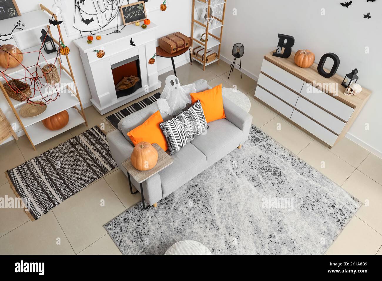 Interior of light living room decorated for Halloween with sofa and ...