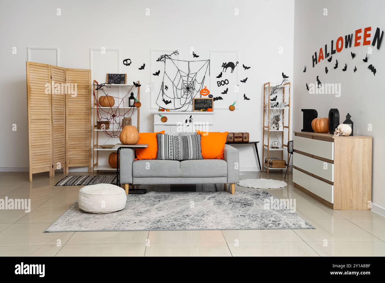 Interior of light living room decorated for Halloween with sofa and ...