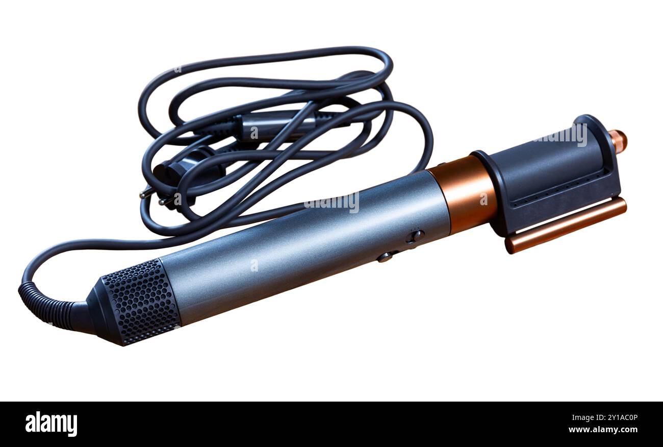 On wooden table there is branded device for creating hairstyles and ...