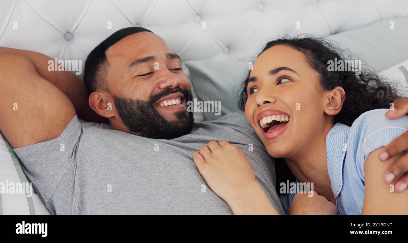 Bed, cuddle and couple with laugh for bonding, comfortable and ...