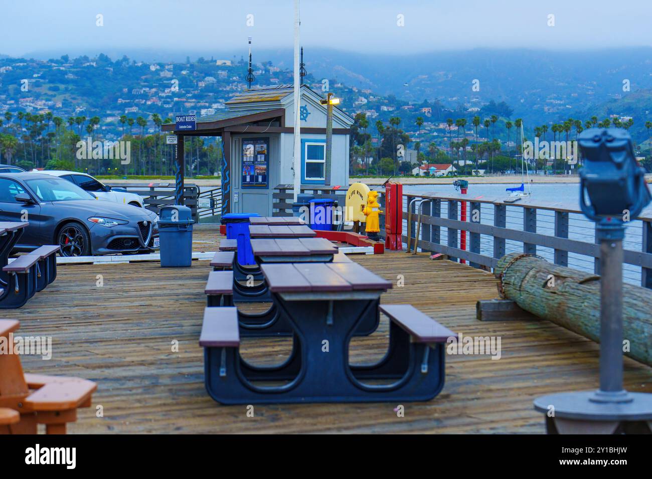 Santa Barbara, California - April 20, 2024: Picnic tables on Stearns Wharf with ocean view in the background. Stock Photo