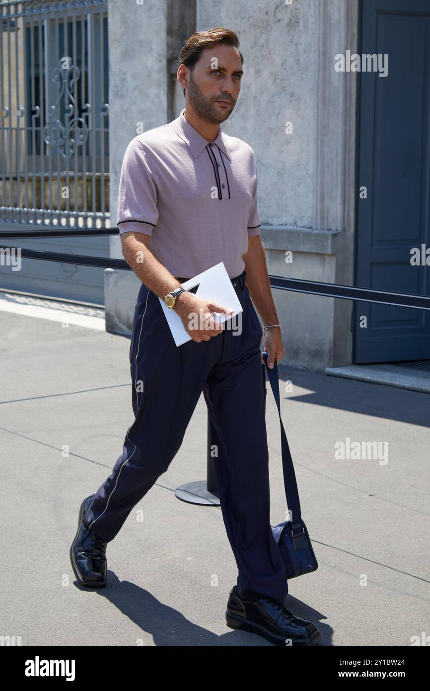 MILAN, ITALY - JUNE 16, 2024: Man with blue trousers and desaturated pink  polo shirt before Prada fashion show, Milan Fashion Week street style Stock  Photo - Alamy