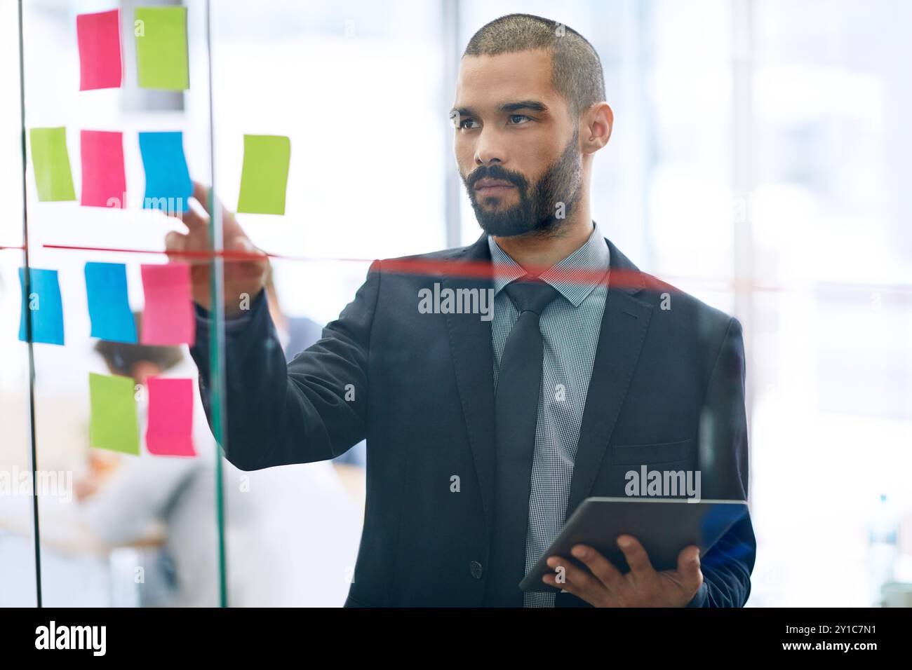 Tablet, sticky note and business man brainstorming ideas, planning ...