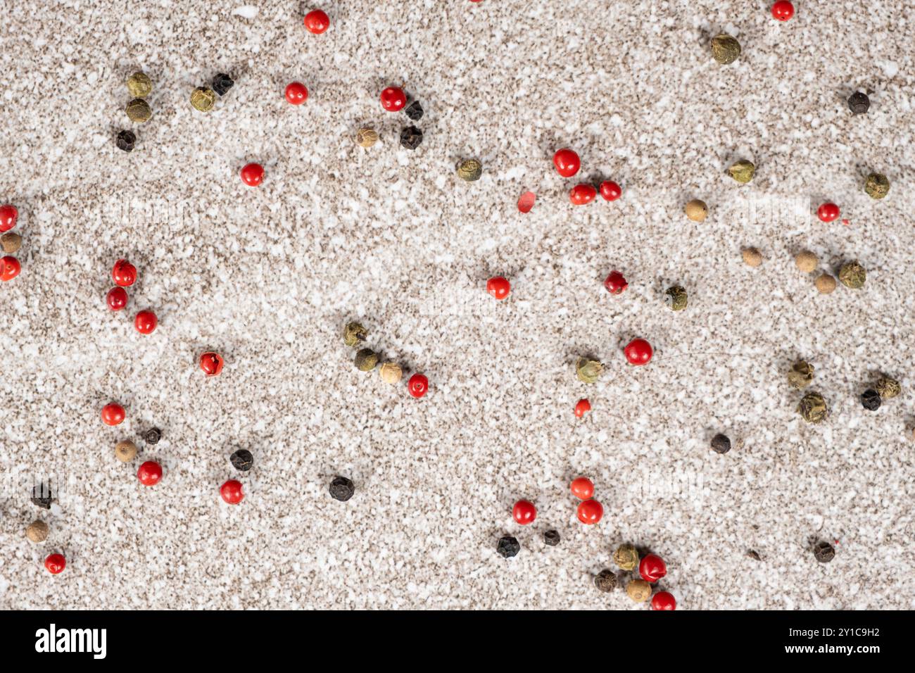 Multicolored peppercorns on a stone gray background. Stock Photo